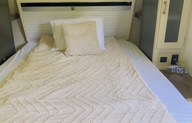 The camper features a FULL SIZE queen murphy bed (many campers have a modified queen.) Two sheet types for you to choose from. Shelves and tables on both sides. Cabinets have lights.