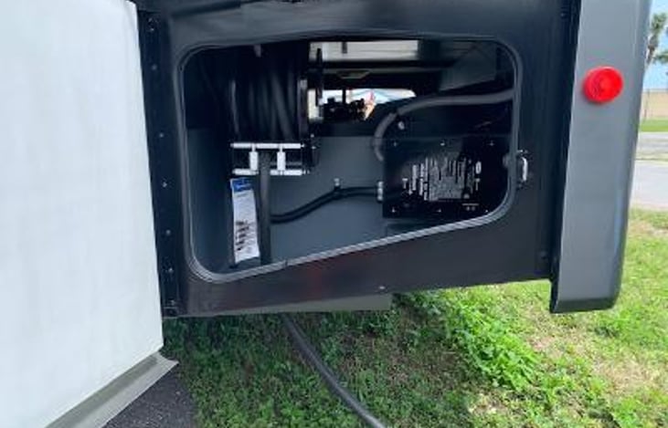 Electrical bay. 50 am0 cable on retractable reel & surge protector.