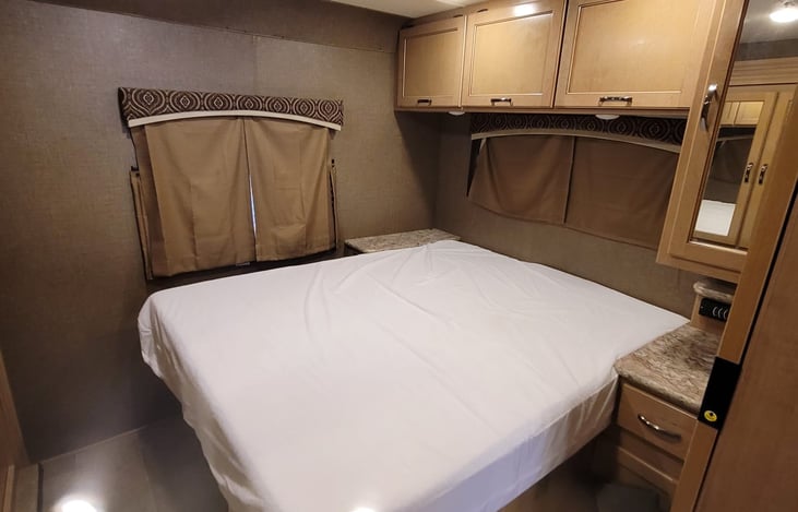 private queen bedroom with a door