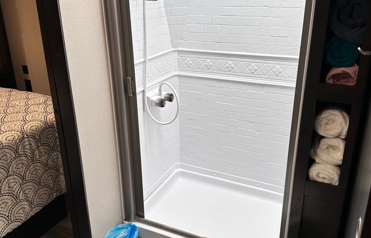 Beautiful shower with rack for shampoo, conditioner and bodywash(which we also provide).