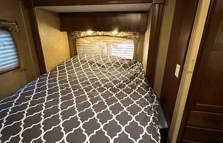 Slide out queen bed with two inch memory foam mattress topper, water proof mattress cover and luxury linens.