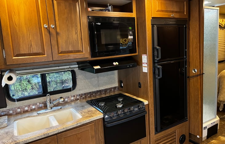 Full kitchen with 3 burner stove and oven. Spacious fridge and double sinks.