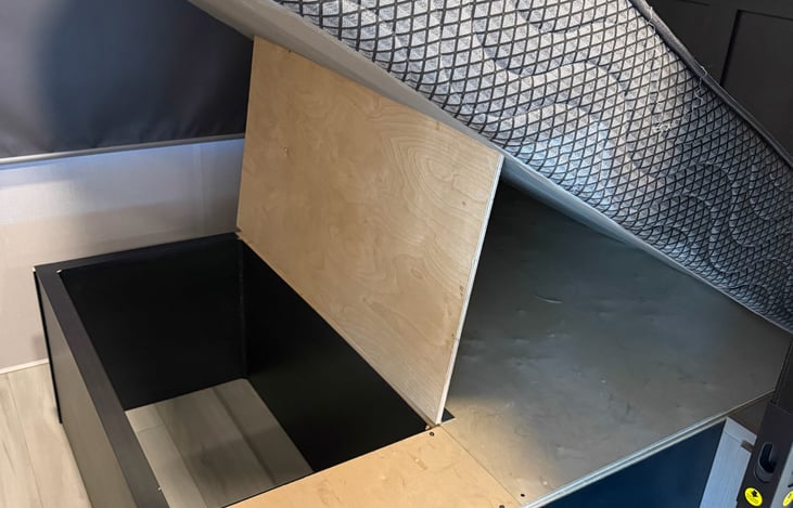 Storage under master queen bed.
