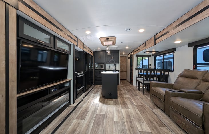 Very spacious space with big screen TV, fireplace, two couches and more.