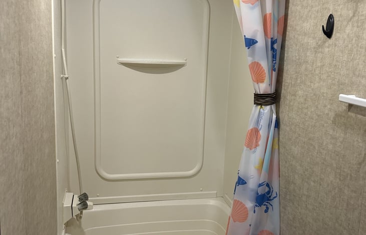 Roomy bathroom with tub/shower combination.