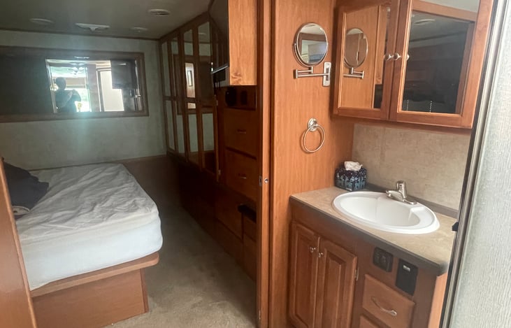 Queen size bed and lots of comforts throughout the motorhome, like this deluxe make-up mirror