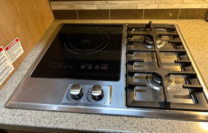 Cooking surface includes two propane grills and two induction surfaces. All cooking pots, pans, tableware, etc. included with RV.