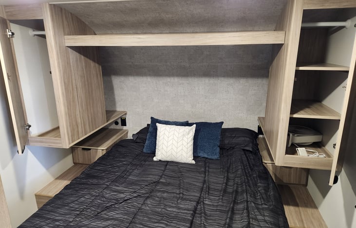 Master bedroom queen with plenty of storage. Lower shelf is a small box fan for those needing it to sleep.