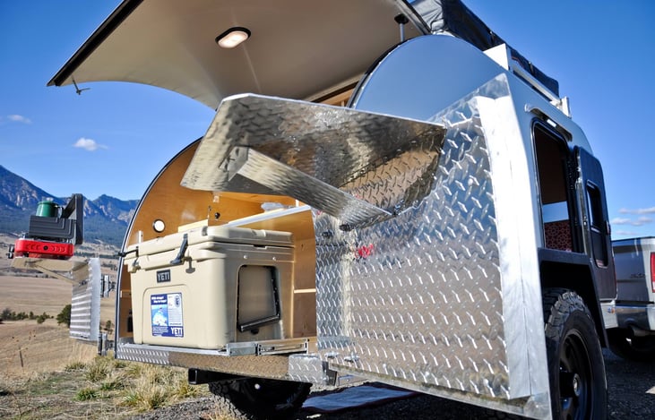 Fold-out galley shelves and slide-out cooler platform