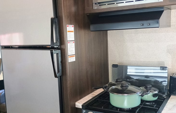 Refrigerator, Freezer, microwave, stove and oven with pots and pans supplied.