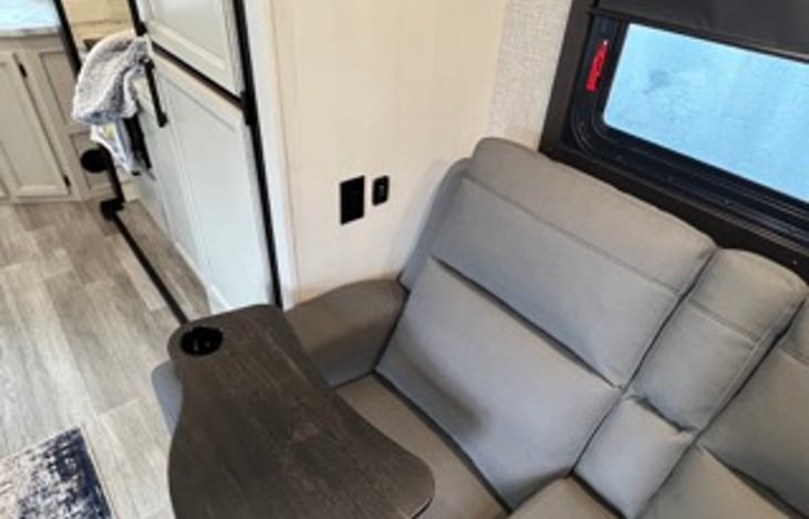 More USB charging plugs on both sides next to recliners.