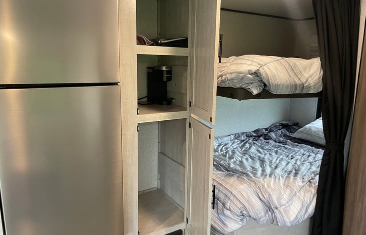 Bunk storage rack and pantry bunk next to bunk beds