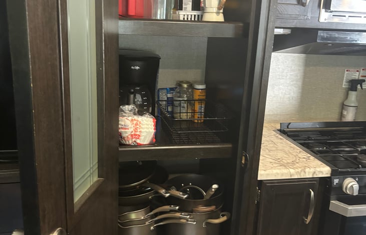 Stocked with cookware, utensils, plates, etc..