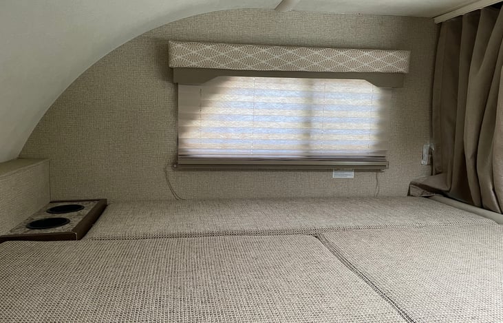 Over cab bed lots of room to sleep two people. Comes with memory foam topper.