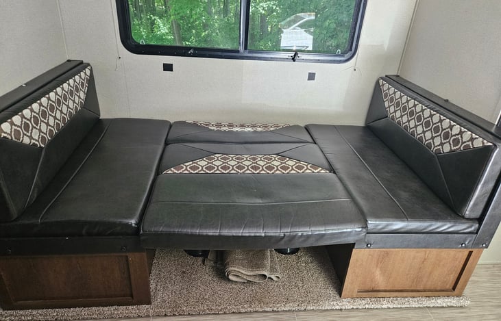 Large versatile dinette, can be used as dining table, couch (if you remove table) or double bed. Pack n play also fits nicely in this area.