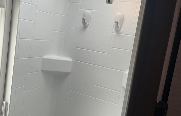 Walk in shower with fully retractable door.