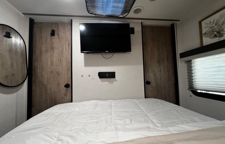 Master bedroom with mounted Tv