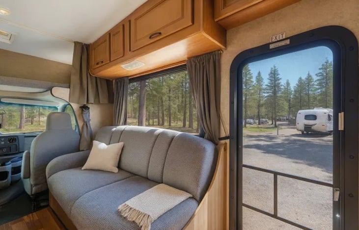 Relax and recharge in this comfortable RV living area — perfect for kicking back after long festival days and sharing good vibes with friends