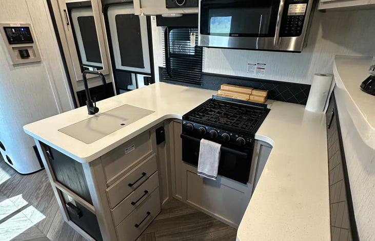 Kitchen set up. There is a Smart TV to the left of microwave. (You can log into youtube/netflix/etc.)
