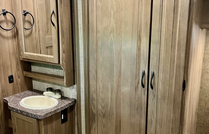 Bathroom sink area and closet storage