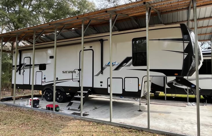Side of unit showing dual entry doors and large awning.