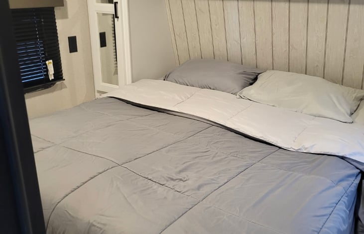 Private queen size bedroom with TV and plenty of storage