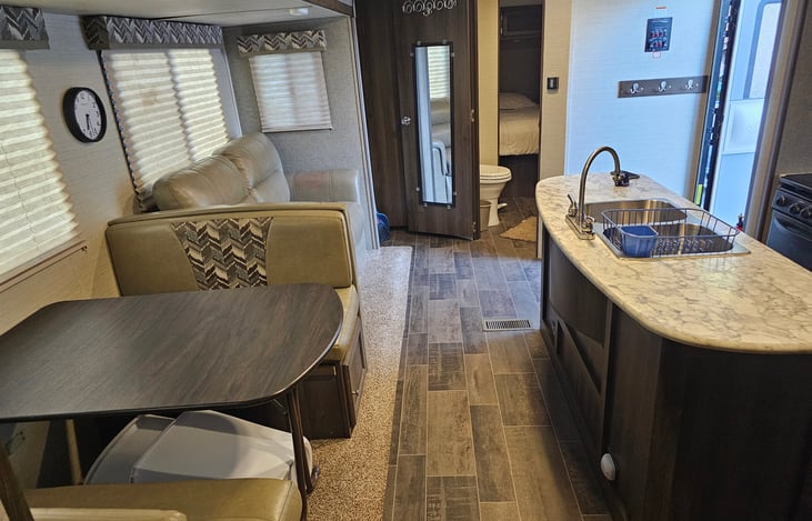 Extra large living area with two slide-outs and an island sink. TV with Roku device. Indoor and outdoor Bluetooth soundbar. Fold out couch and convertible sleeper dinette.