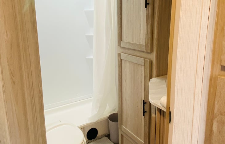 Roomy bathroom with standard size shower