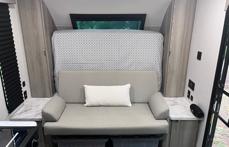 Comfortable couch for additional indoor seating.  Side tables with electric outlets on each side.  Bluetooth speaker can be removed and taken outside.