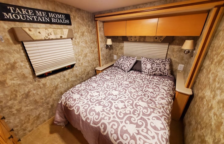 Queen bed in private bedroom with pillowtop mattress cover.