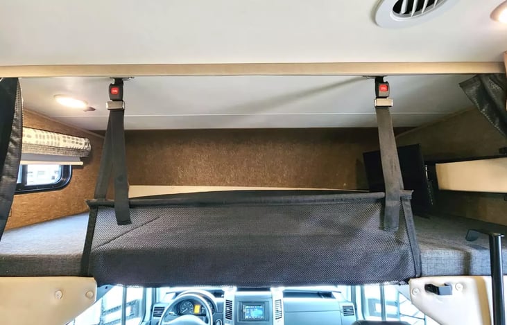 Protective net can be raised to prevent falling out of the bunk