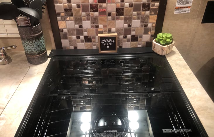 Cooktop with glass cover covering the burners