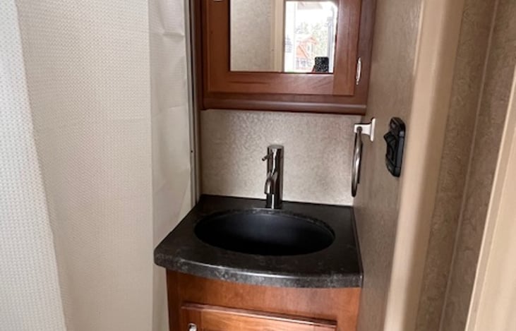 Plenty of bathroom storage over and under sink.