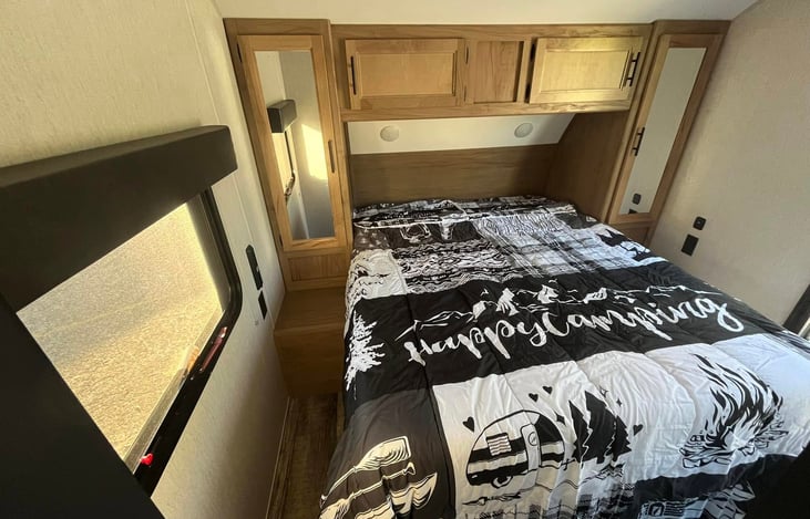 Queen size bed with abundance of storage and and entry door!