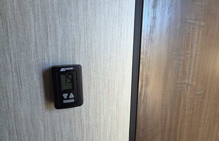 Thermostat keeps the camper comfortable with AC, heat, auto, high, low, and fan settings.