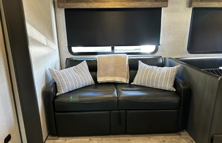 2 recliners which also folds down to make a bed, relax and watch tv.