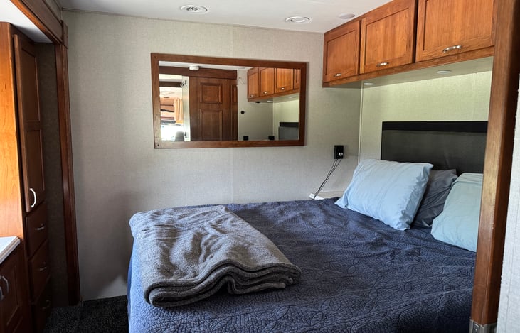 King size master bed with Purple mattress.  Storage above and under the bed.  Bedside tables on each side of the bed.