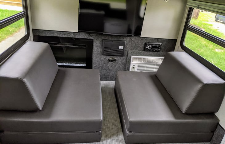 Setup with folding futons. Both futons put together turns these comfy seats into a comfy queen sized bed.