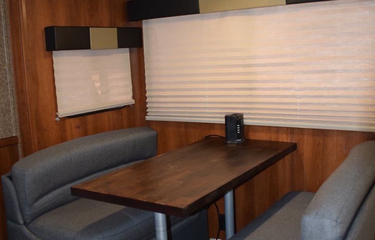 Dinette folds out to a bed.
Butcher block table. 
Charging port
Storage under seats