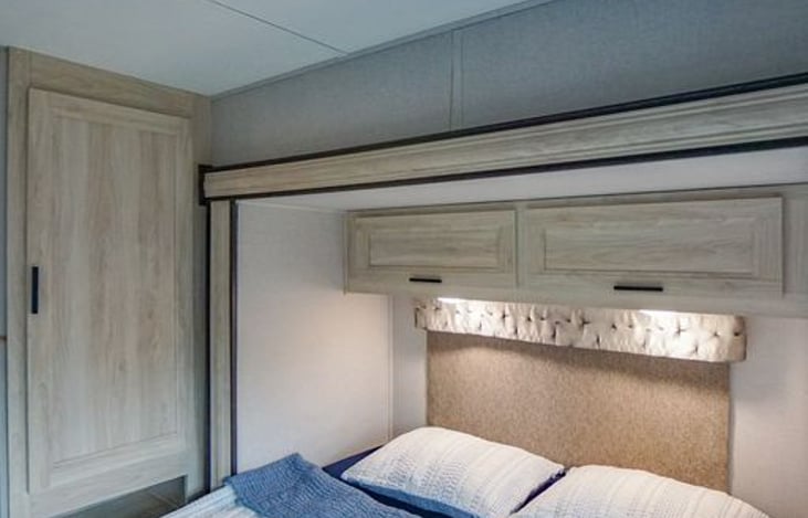 Cabinet with pole for hangers.