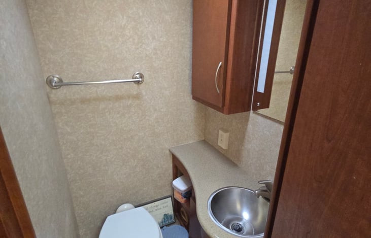 New commode, large makeup mirror cabinet storage below the sink as well as beside the sink. Blackwater sewage tablets are provided.