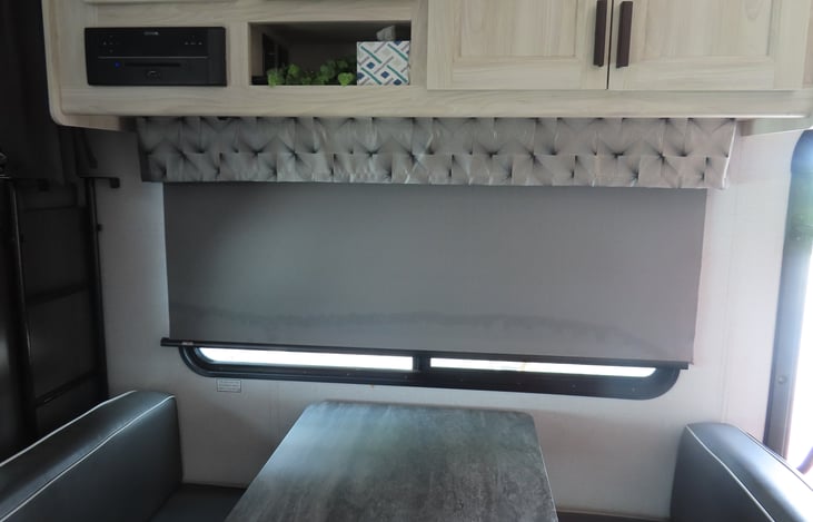 Full size dinette beside a large, tinted picture window.