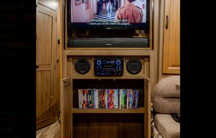 Entertainment center with DVD collection and surround sound system
