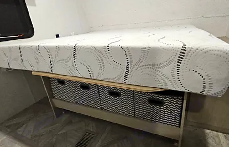 Under-bed storage bins in the master bedroom.