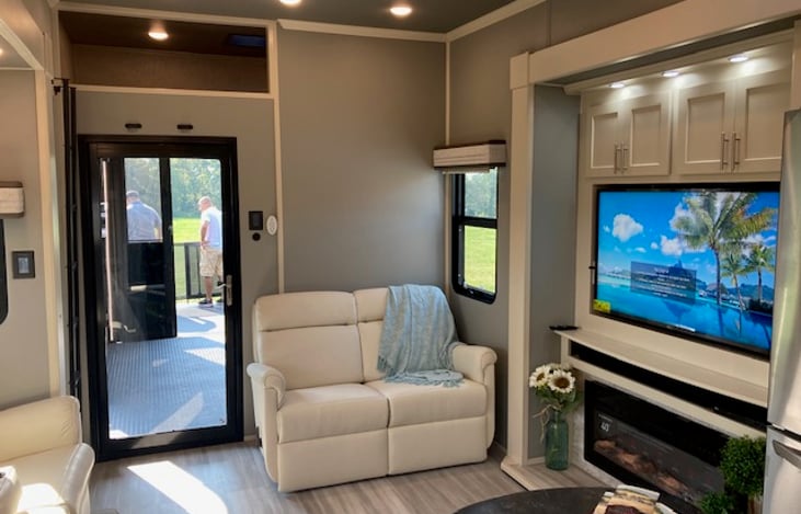 Love seat, bunk full bed overhead with TV, fireplace, 65" Samsung TV with Direct TV, DVD and loveseat