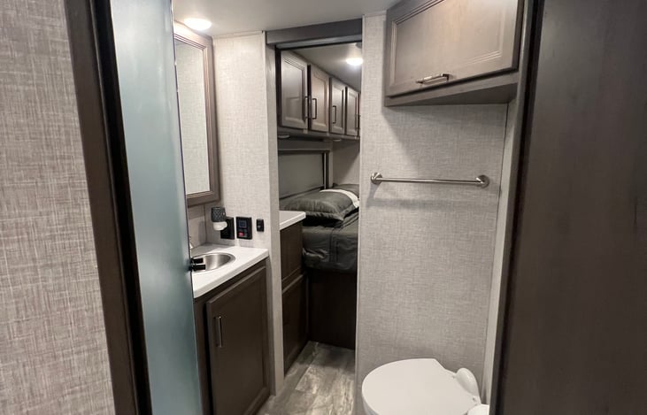 Walk through bathroom with shower with tankless hot water heater