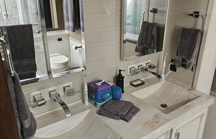 Master bath has dual vanity sinks and medicine cabinet mirrors with plenty of storage and drawers underneath the sinks
