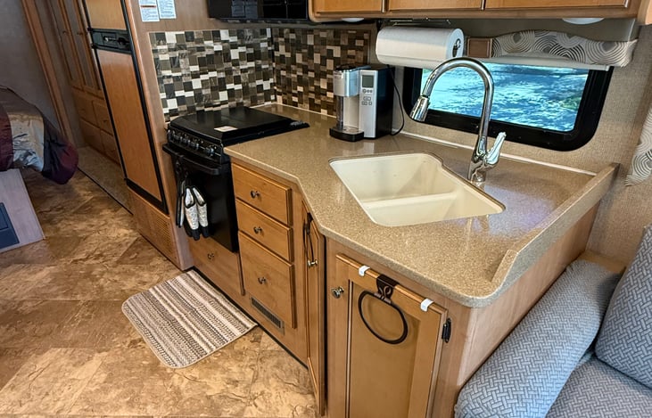 Full Kitchen. Refrigerator, stove, oven, microwave, Pods coffee maker.