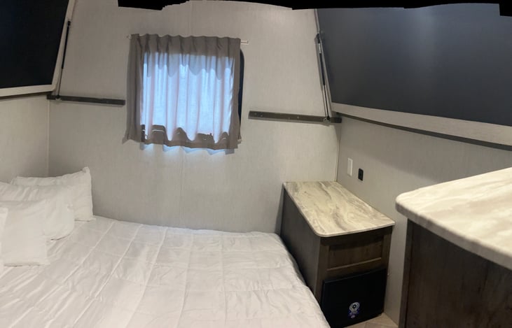 Rear couch made into queen size bed. With both bunks folded up