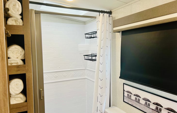 Full bath with shower, porcelain toilet, medicine cabinet and stainless sink. Bath, Hand and Wash Towels and provided for your trip.